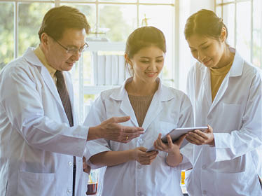 Group of asian scientist using tablet computer and analyzing data research information together in the laboratary
