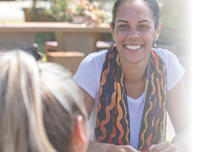 Close-up of young aboriginal students studying together outdoors in the sun in Australia 